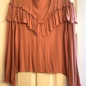 Leigh Blouse v-neck, ruffled front & back. 100% viscose, elastic wrist.